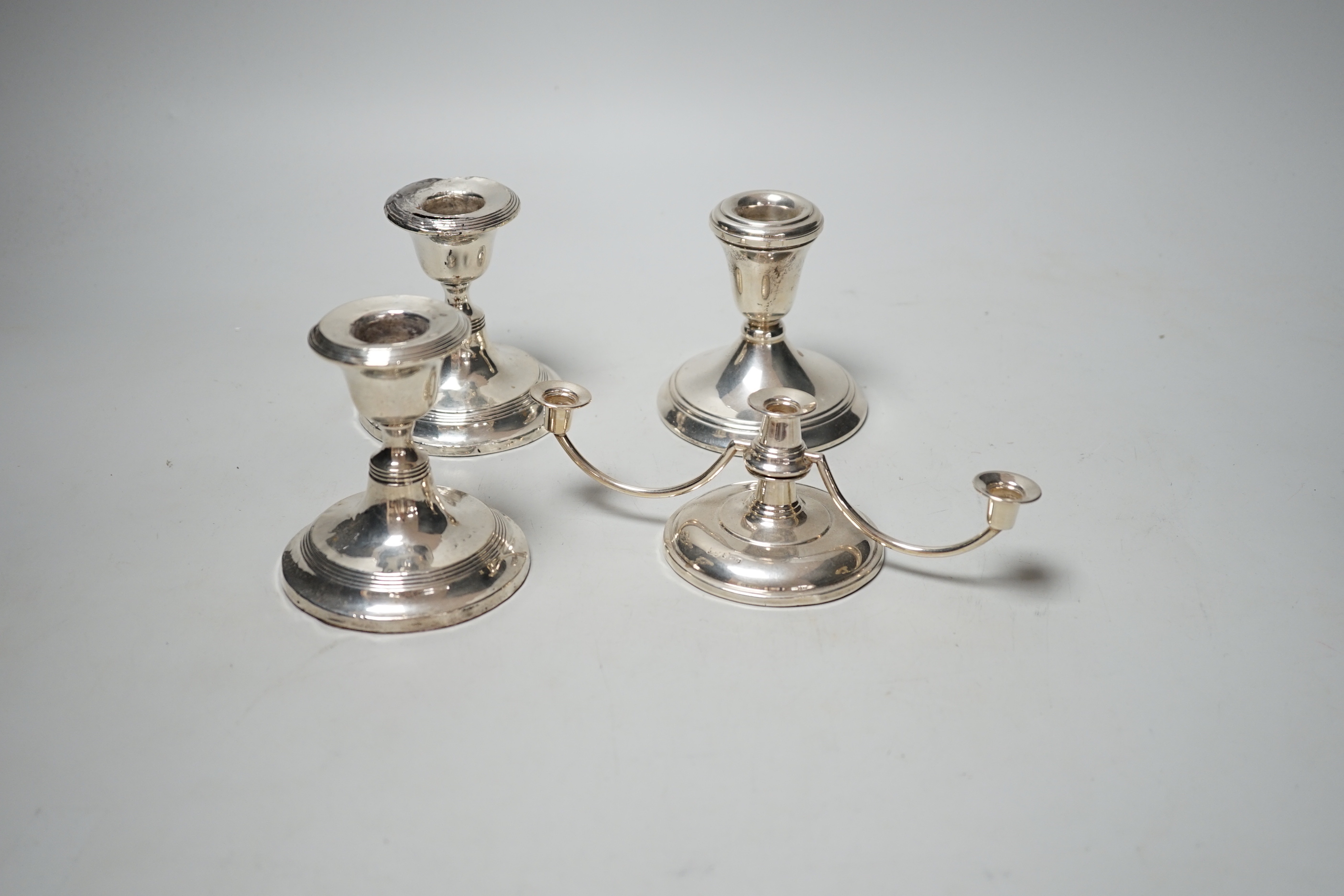 A pair of silver mounted dwarf candlesticks (a.f.), one other dwarf candlestick and a modern silver dwarf candelabrum.